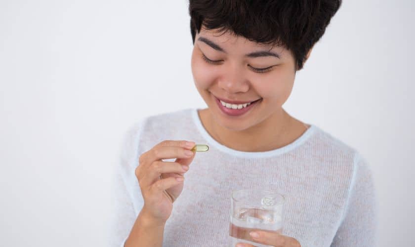 A woman taking antibiotic for gum disease 